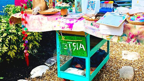 cart with art supplies in a garden